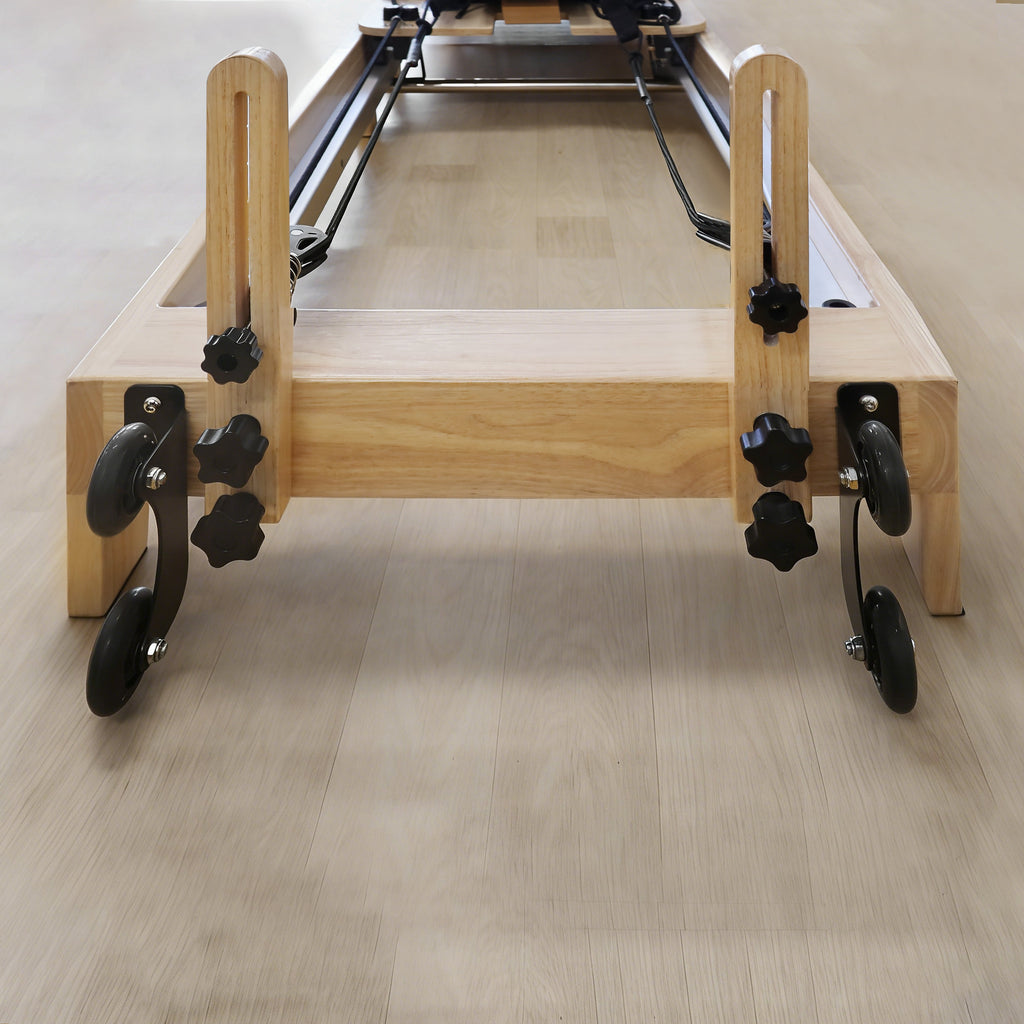 Home pilates machine with adjustable spring resistance