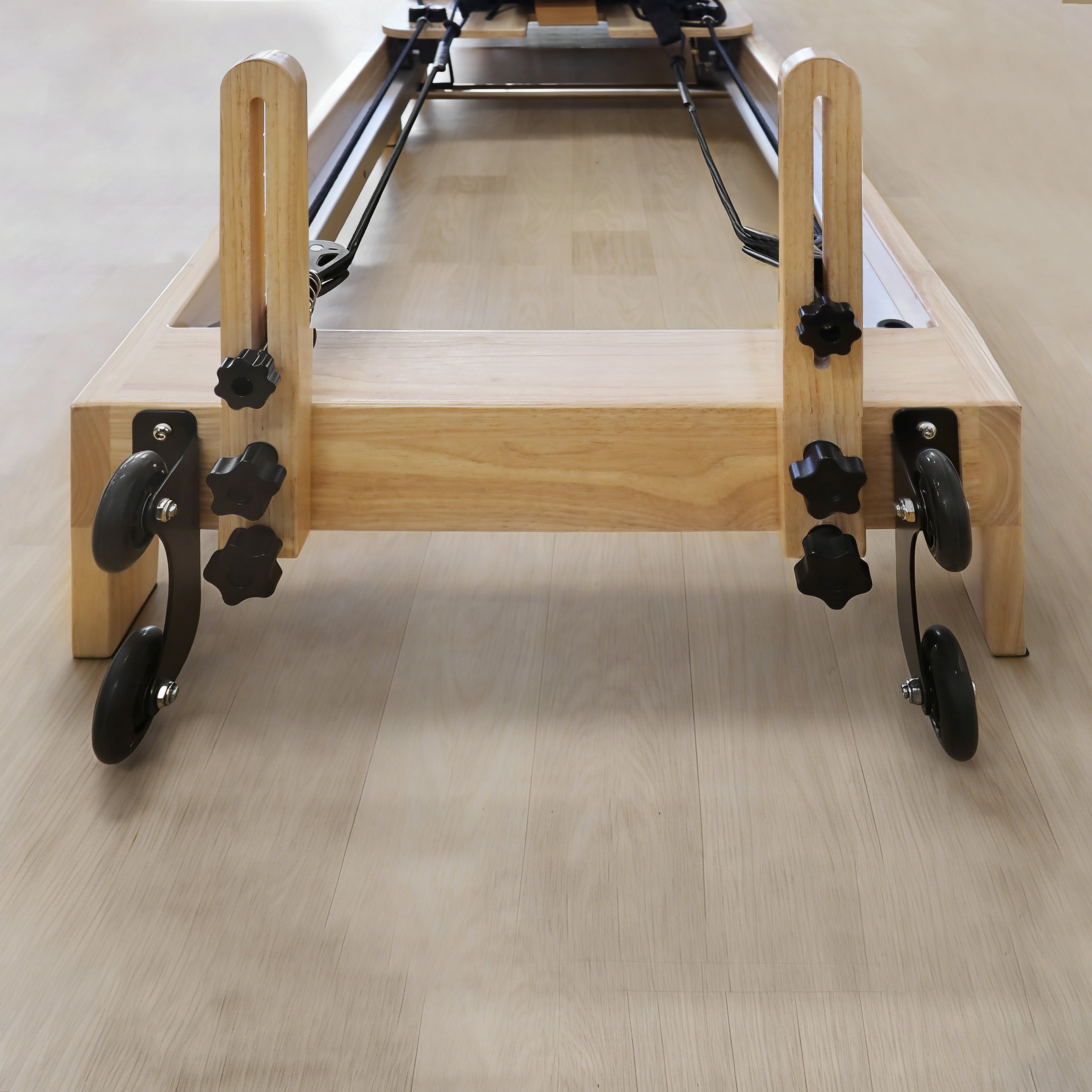 Home pilates machine with adjustable spring resistance