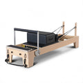 Oak wood pilates reformer with solid frame, front view